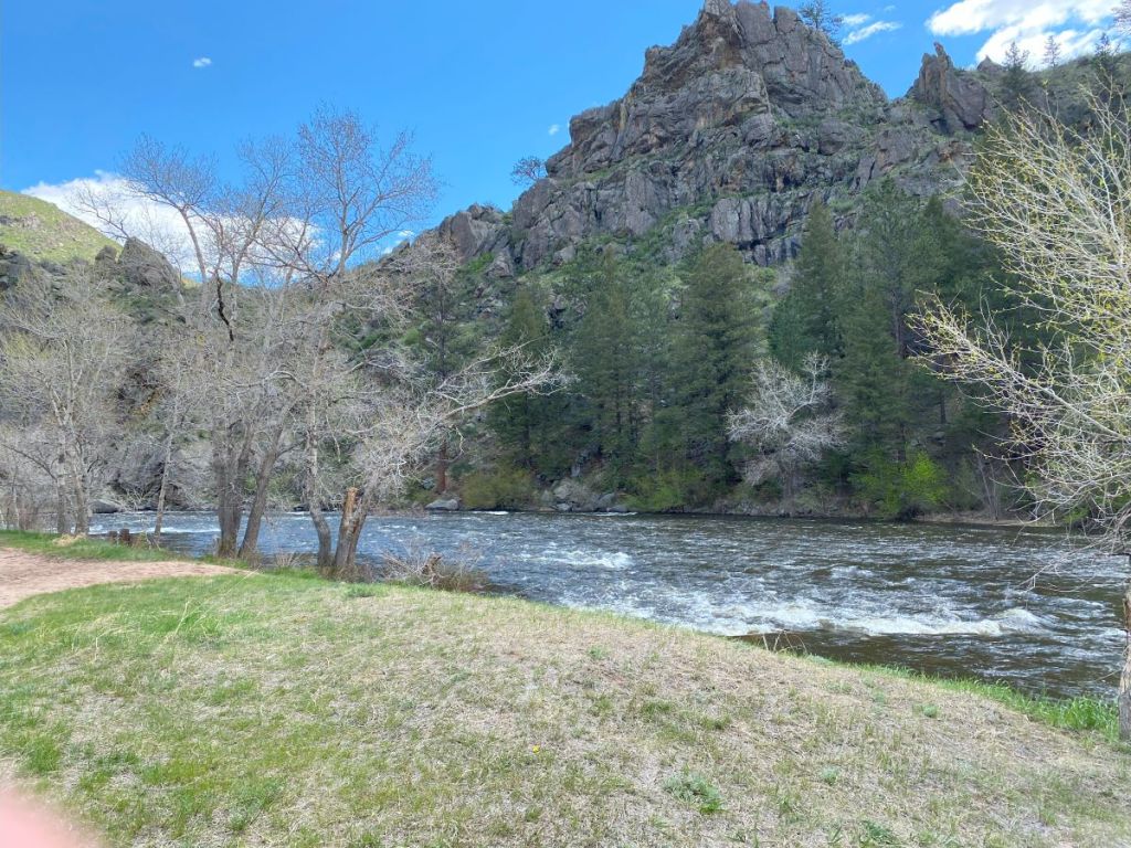 The Poudre River runs under a rock outcropping