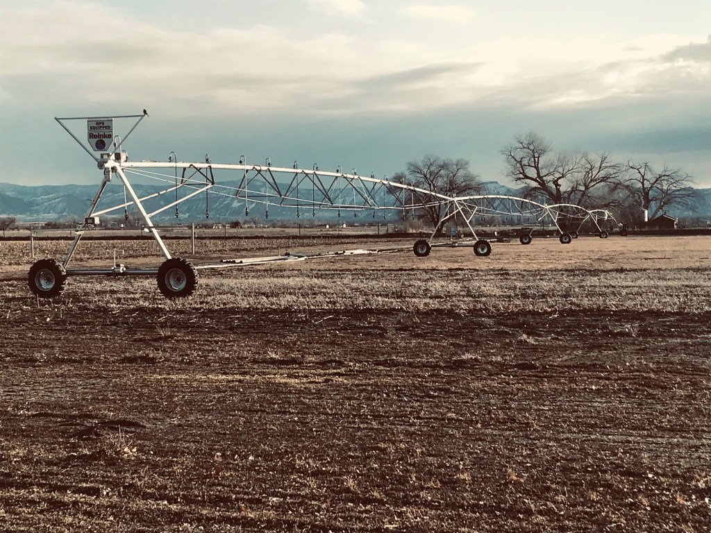 A linear move irrigation system on a brown field in winter