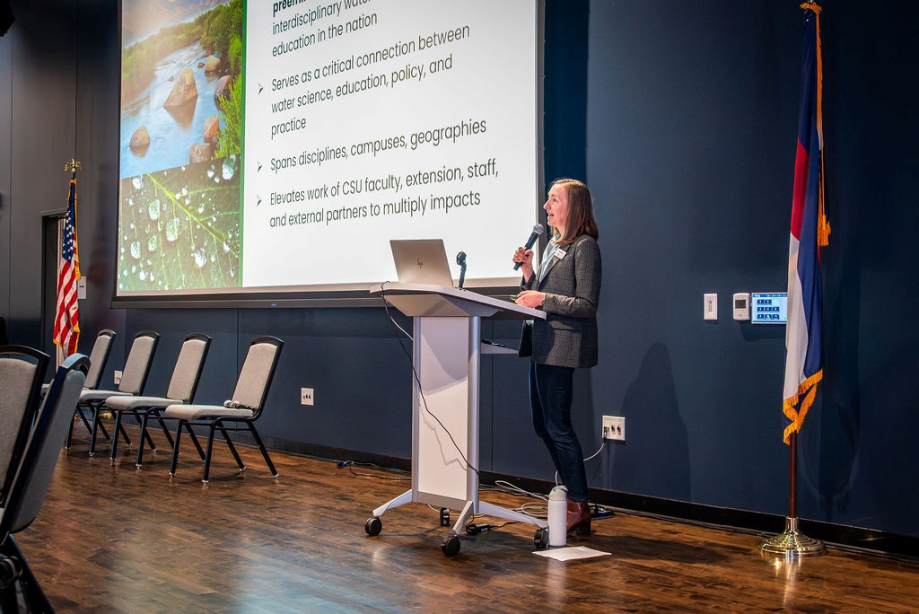 Karen Schlatter addressing the audience during opening remarks.