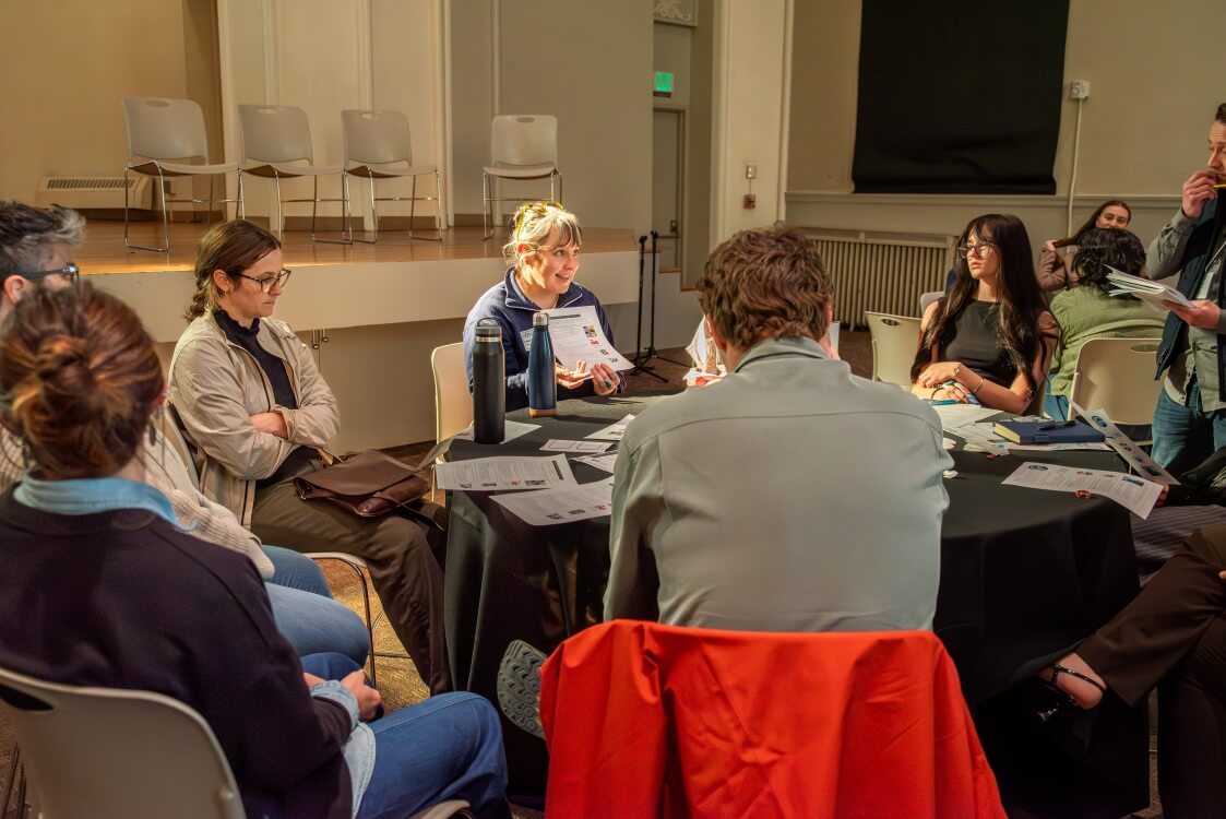 Colorado Water Fellows and program staff in discussion while sitting at a round table.