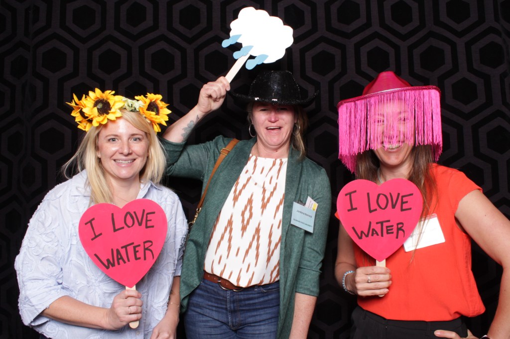 People pose with props in photo booth
