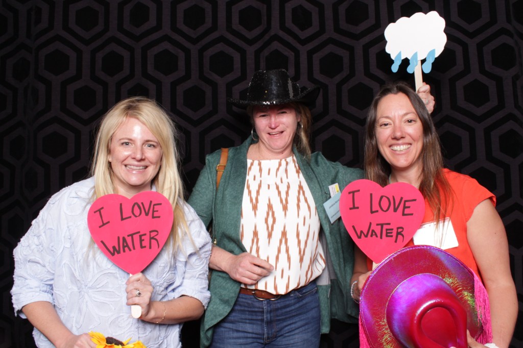 People pose with props in photo booth