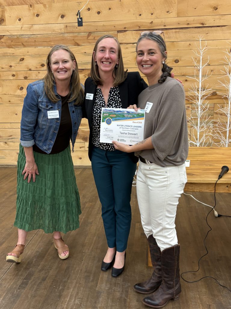 Karen Schlatter poses with NoCo Foundation representative and Water Literate Leaders graduate