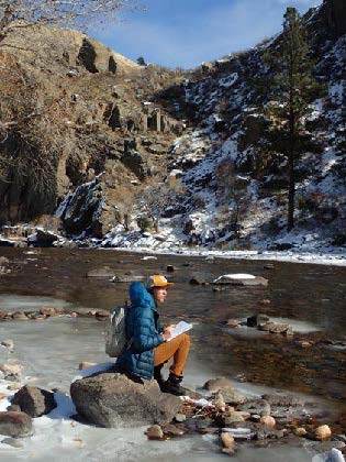 students writing poetry on Poudre River